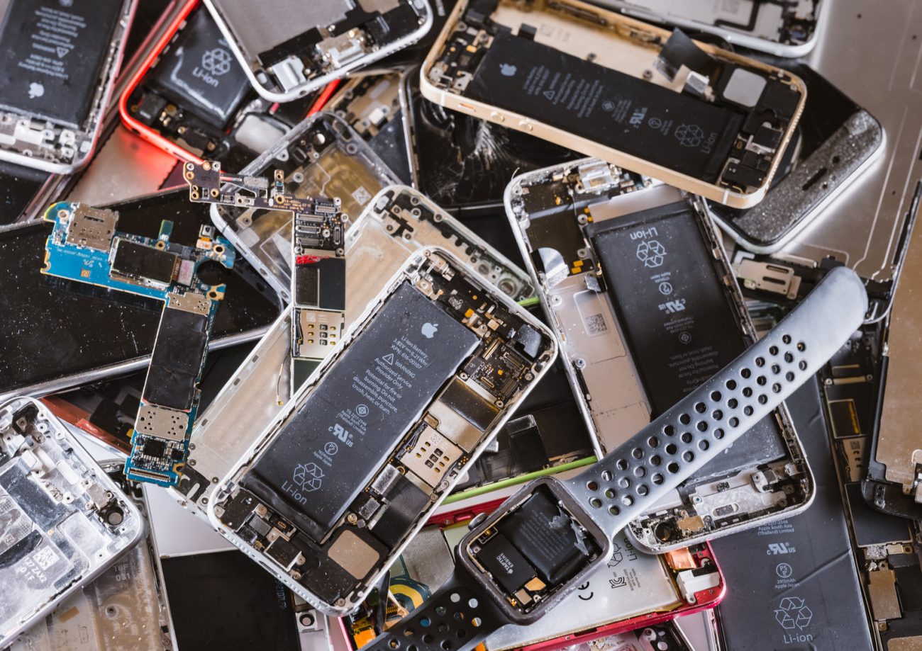 A pile of mobile phones and smart watches with their back covers removed